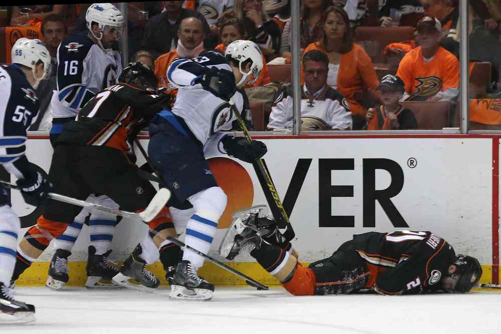 Robert Gauthier / Tribune Media TNS
The Anaheim Ducks' Kyle Palmieri falls to the ice in apparent pain as others battle for the puck in the first period of Game 1 at the Honda Center.