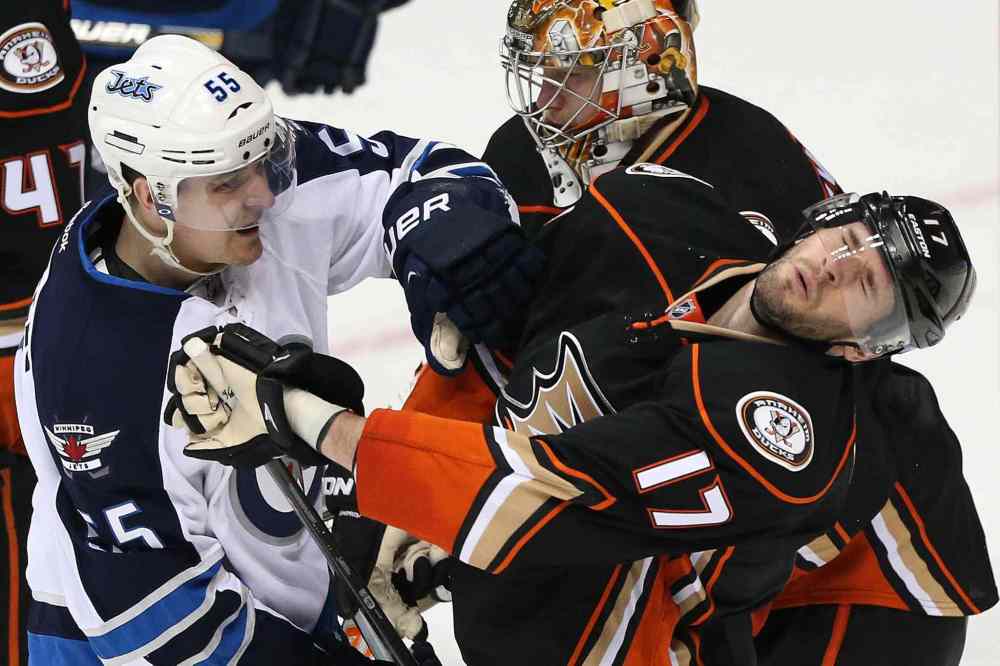 Robert Gauthier / Tribune Media TNS
The Anaheim Ducks' Ryan Kesler (17) takes a hard shove in the face from the Winnipeg Jets' Mark Scheifele, who was penalized for roughing in the second period.