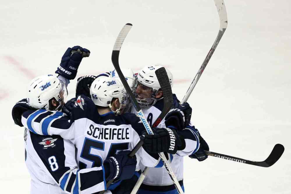 Robert Gauthier / Tribune Media TNS
Winnipeg Jets teammates mob winger Drew Stafford after he scored a goal early in the second period against the Anaheim Ducks.