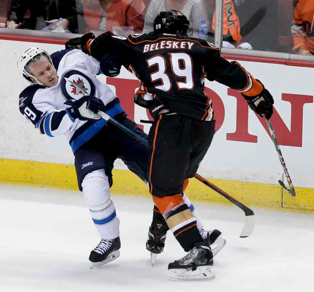 Chris Carlson / The Associated Press
Anaheim Ducks left wing Matt Beleskey, right, checks Winnipeg Jets defenceman Tobias Enstrom during the second period.