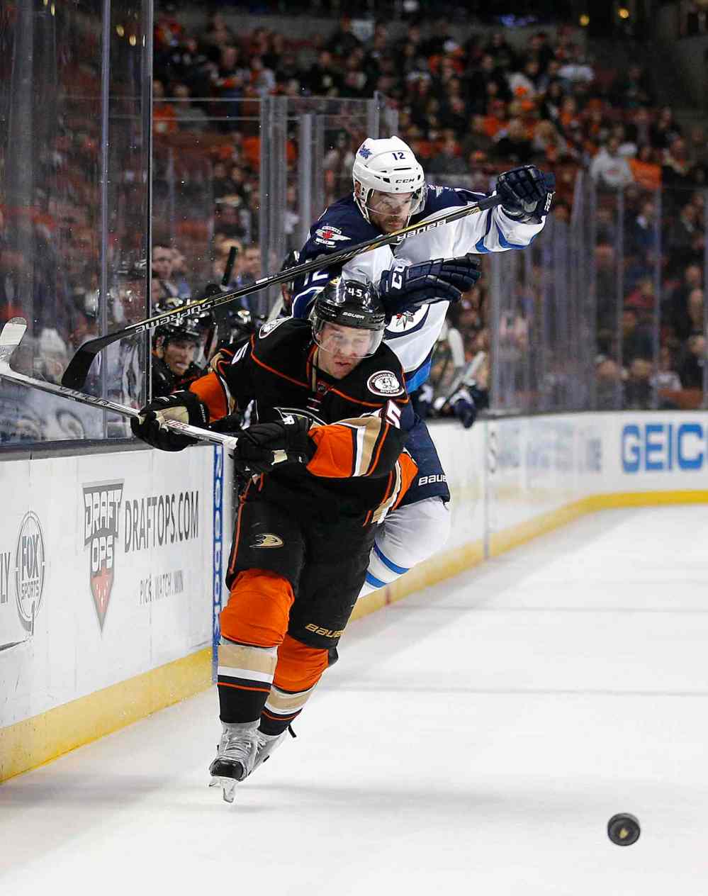 Jae C. Hong / The Associated Press
Winnipeg Jets' Drew Stafford, top, avoids a collision with Anaheim Ducks' Sami Vatanen as they chase the puck during the first period.