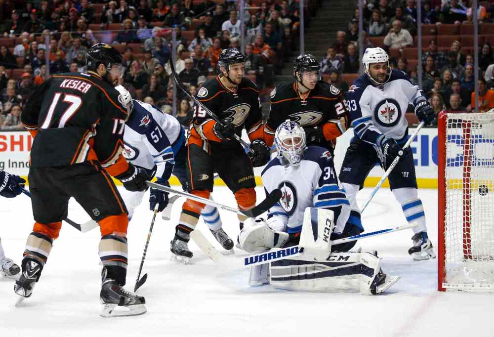 Jae C. Hong / The Associated Press
Anaheim Ducks' Ryan Kesler (17) scores against Winnipeg Jets goalie Michael Hutchinson (34) as teammate Chris Stewart (29) and Mike Santorelli (25) watch during the second period.