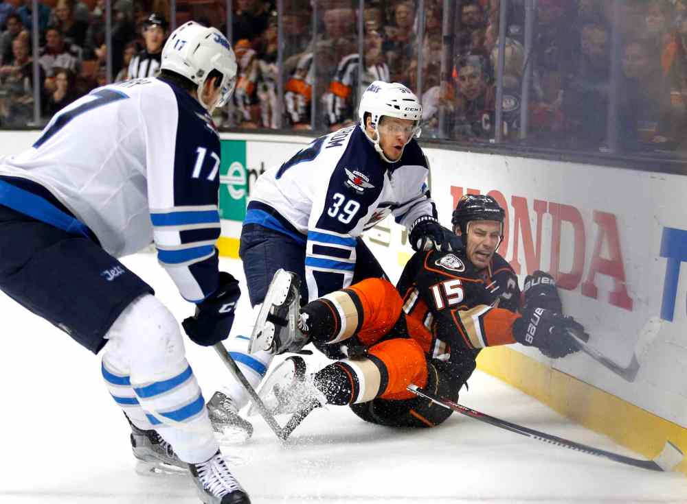 Jae C. Hong / The Associated Press
Anaheim Ducks' Ryan Getzlaf, right, takes a tumble after he was pushed by Winnipeg Jets' Toby Enstrom in second period.