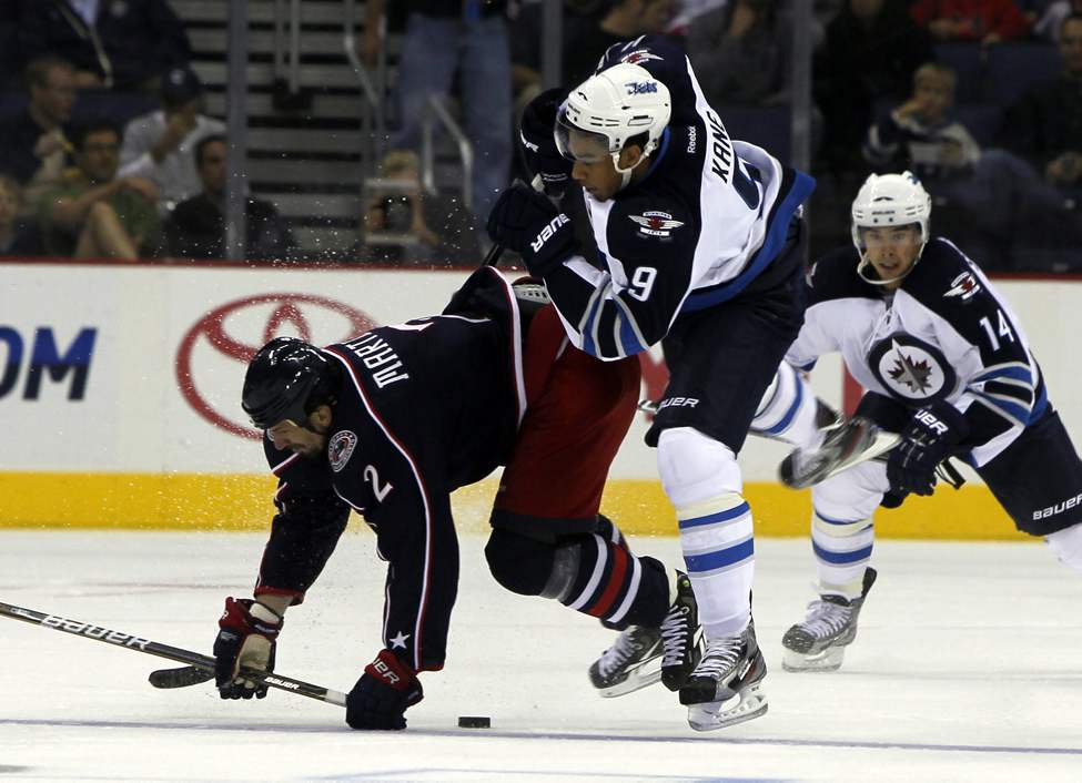 The Winnipeg Jets vs.Columbus Blue Jackets at Nationwide Arena in Columbus, Ohio. First Period action. Jets Evander Kane gets creamed by Blue Jackets #2 Radek Martinek. Sept. 20, 2011 (BORIS MINKEVICH / WINNIPEG FREE PRESS)