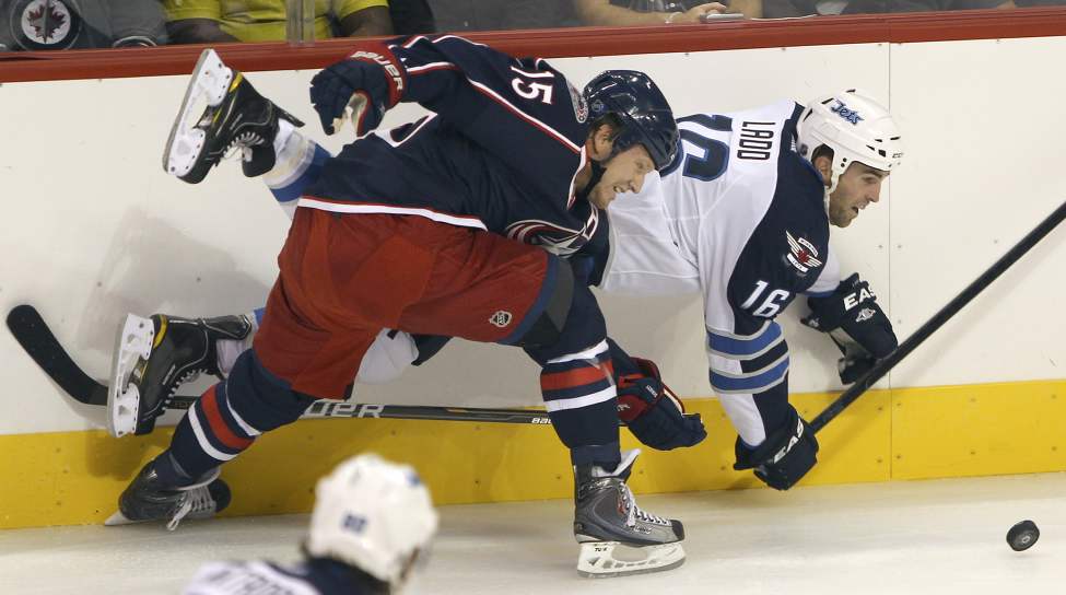 Winnipeg Jets Andrew Ladd, rear, ties it up with Columbus Blue Jackets Derek Dorsett during first period NHL preseason hockey in Winnipeg Tuesday. (JOE BRYKSA / WINNIPEG FREE PRESS)