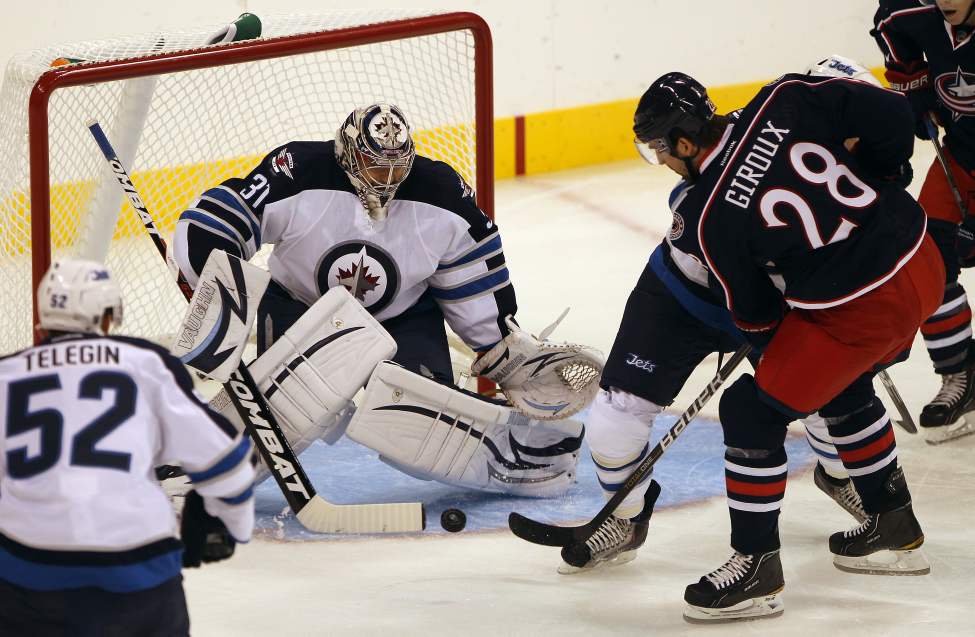 Winnipeg Jets goaltender Ondrej Pavelec stops Columbus Blue Jackets Alexandre Giroux during first period NHL preseason hockey in Winnipeg Tuesday. (JOE BRYKSA / WINNIPEG FREE PRESS)
