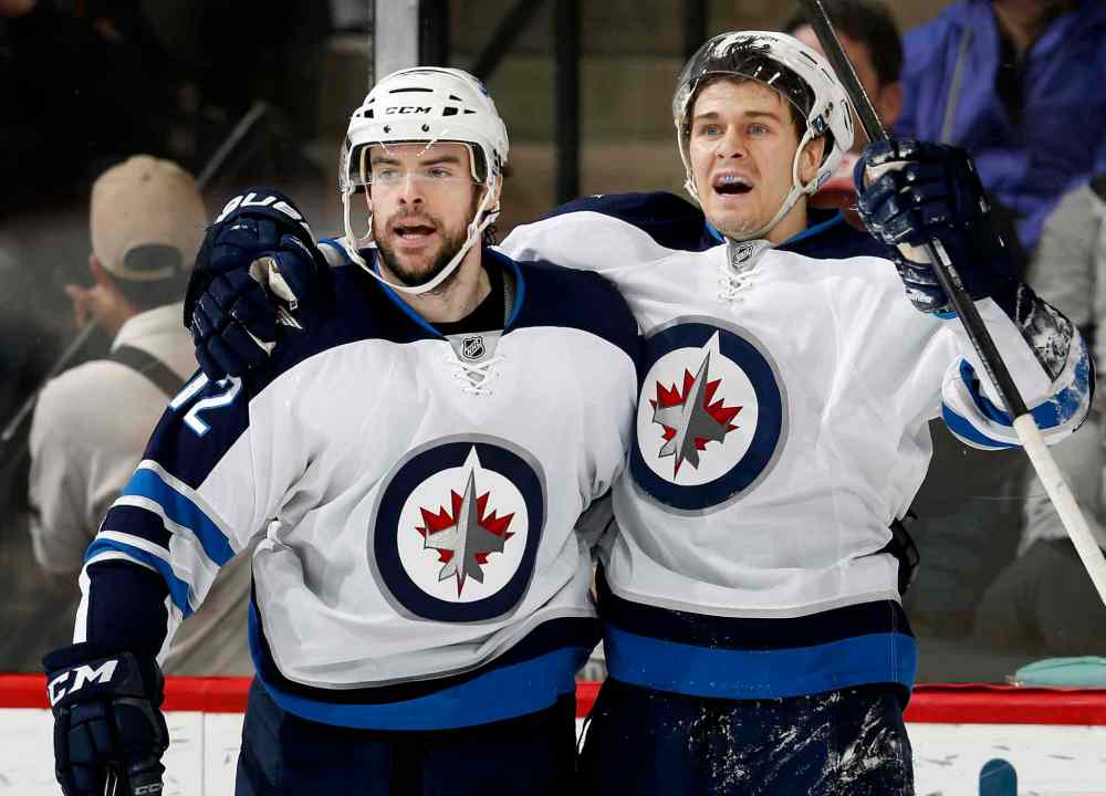 Carlos Gonzalez / Tribune Media TNS
Winnipeg Jets' Drew Stafford (12) and Mark Scheifele (55) celebrate Stafford's game-winning second-period goal on Monday at Xcel Energy Center in St. Paul, Minn.