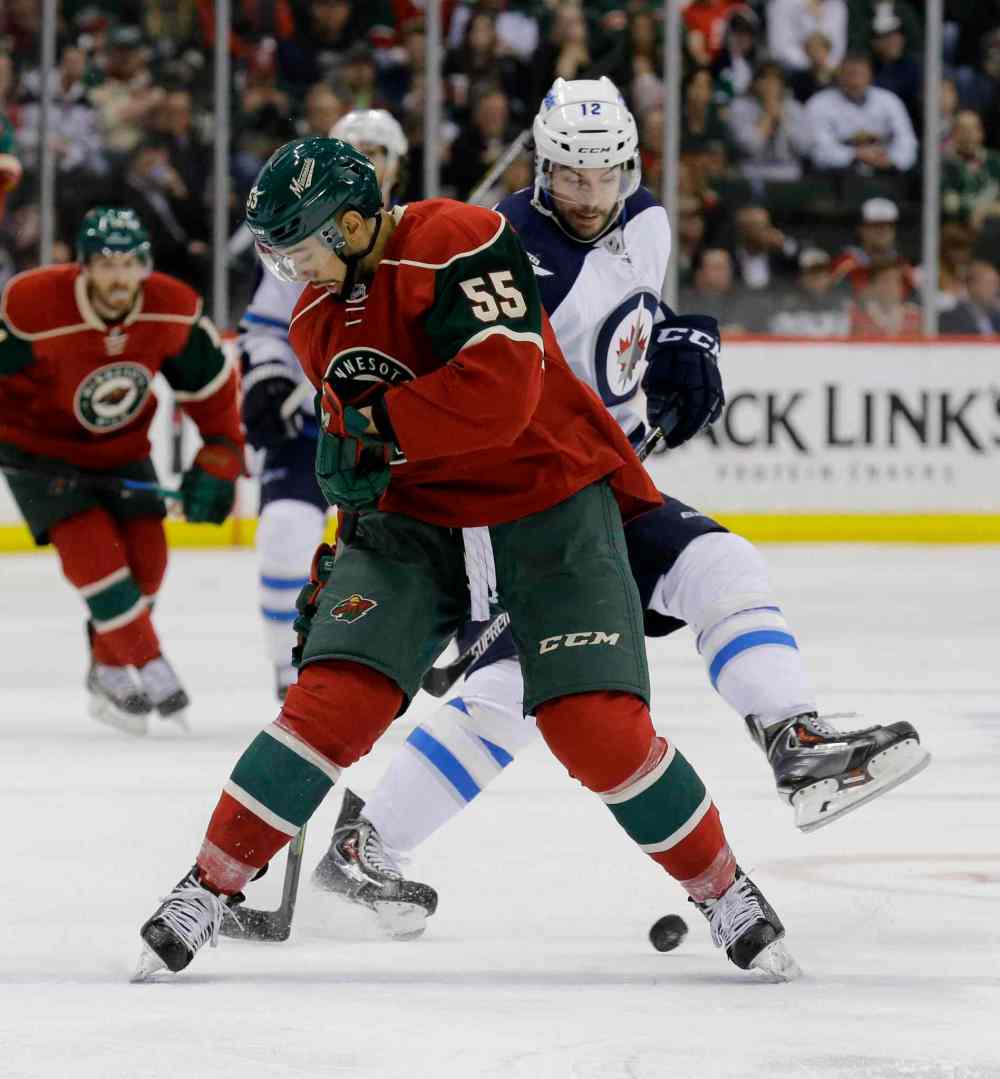 Ann Heisenfelt / The Associated Press
Minnesota Wild defenseman Matt Dumba (55) and Winnipeg Jets right wing Drew Stafford (12) battle for the puck during the second period of Monday's game. The Jets won the game 2-0.