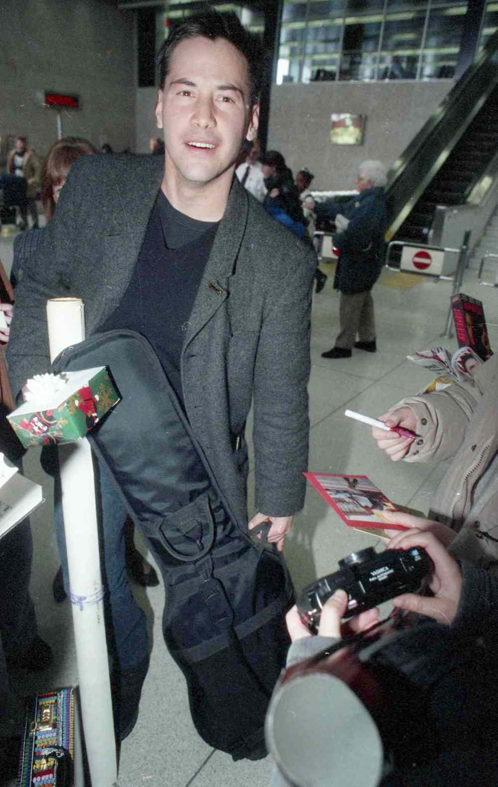 COLIN CORNEAU / WINNIPEG FREE PRESS Files
Keanu Reeves arrives in Winnipeg in December 1994 and signs autographs while waiting for his luggage at the airport. He was in Winnipeg starring in the MTC production of Hamlet.