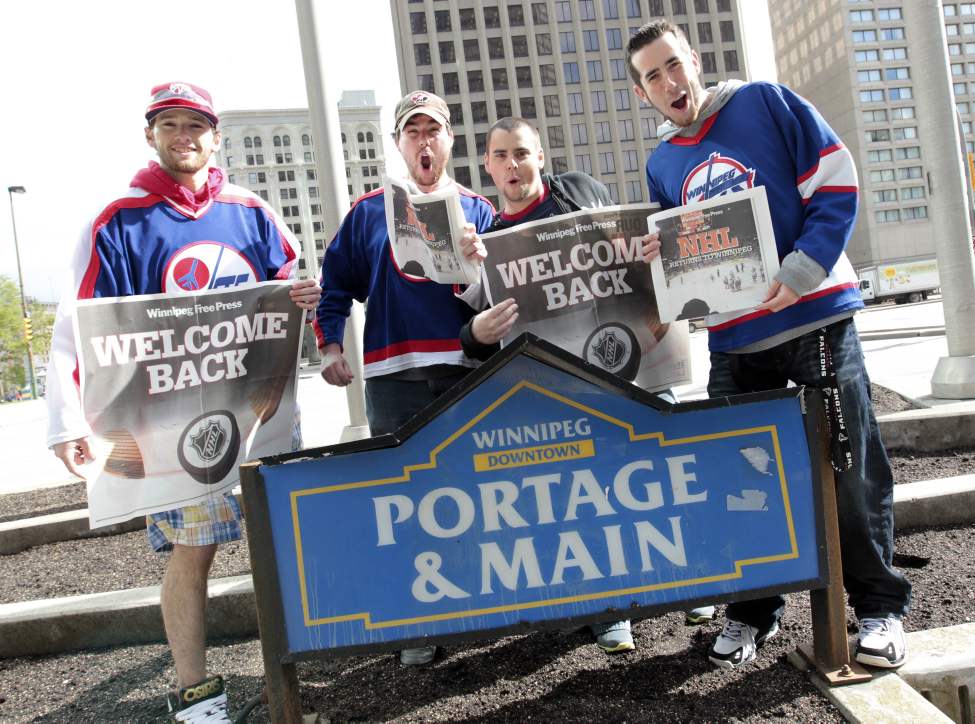 Hockey fans gathered at Portage and Main to celebrate the return of the NHL to Winnipeg, MB. (l-r) Mark Patton, Dana Judd, Damien Lemoine and Miguel Marcoux arrived early at Portage and Main for the party. (MIKE DEAL / WINNIPEG FREE PRESS)