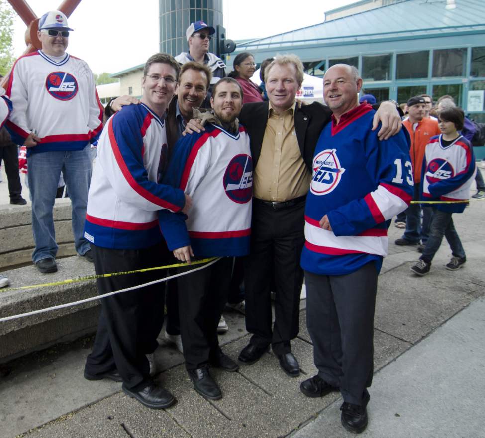 Winnipeg hockey supporters pose with former Winnipeg Jet and currect city councillor Thomas Steen at The Forks in Winnipeg, Tuesday May 31, 2011 after the announcement that an NHL team will be returning to the city after 15 years.
(DAVID LIPNOWSKI / THE CANADIAN PRESS)