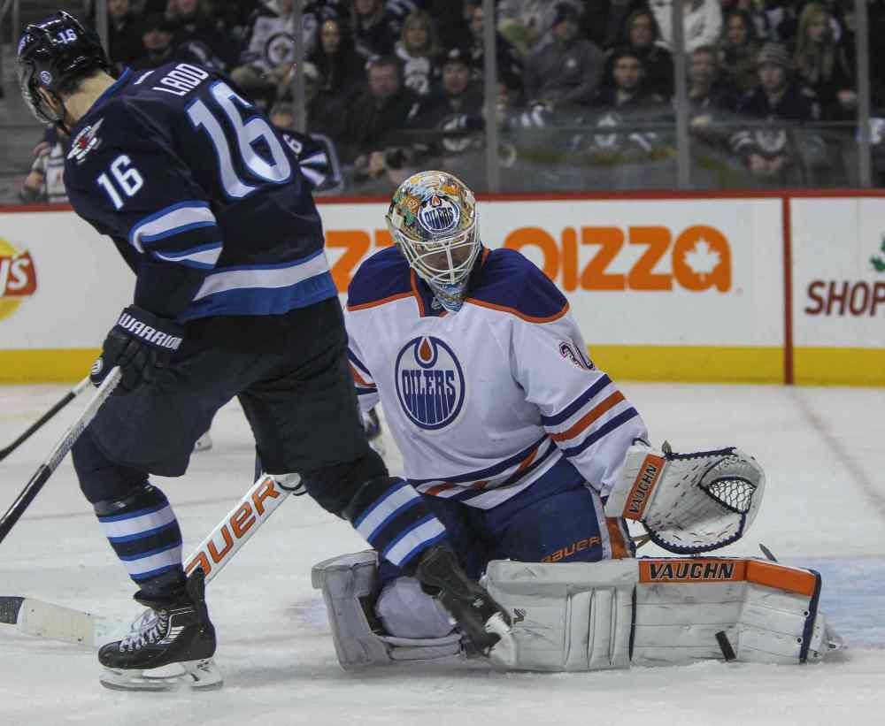 MIKE DEAL / WINNIPEG FREE PRESS
Winnipeg Jets' Andrew Ladd (16) tries to deflect the puck against the Edmonton Oilers' goaltender Ben Scrivens (30).