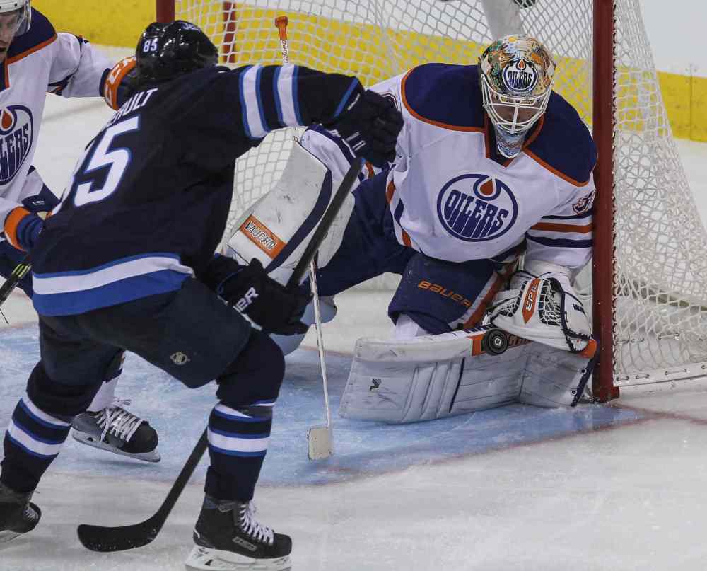 MIKE DEAL / WINNIPEG FREE PRESS
Winnipeg Jets' Mathieu Perreault (85) tries to get the puck past Edmonton Oilers' goaltender Ben Scrivens (30) during NHL action in Winnipeg Wednesday at MTS Centre. 141203 - Wednesday, December 03, 2014 - (MIKE DEAL / WINNIPEG FREE PRESS)