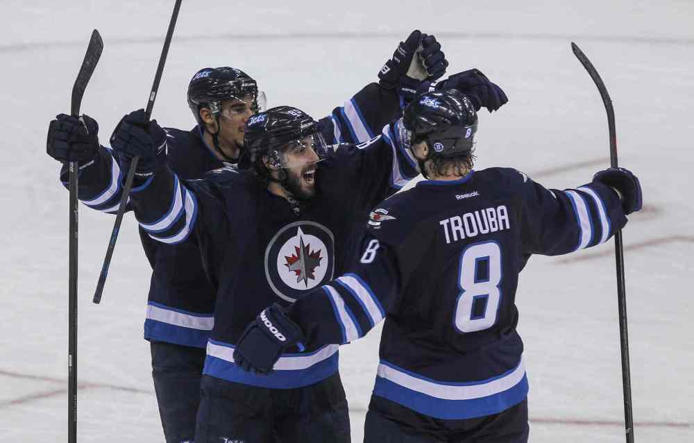 MIKE DEAL / WINNIPEG FREE PRESS
Winnipeg Jets' Mathieu Perreault (85) celebrates his game-winning goal in overtime (3-2) with Evander Kane (9) and Jacob Trouba (8) against the Edmonton Oilers.