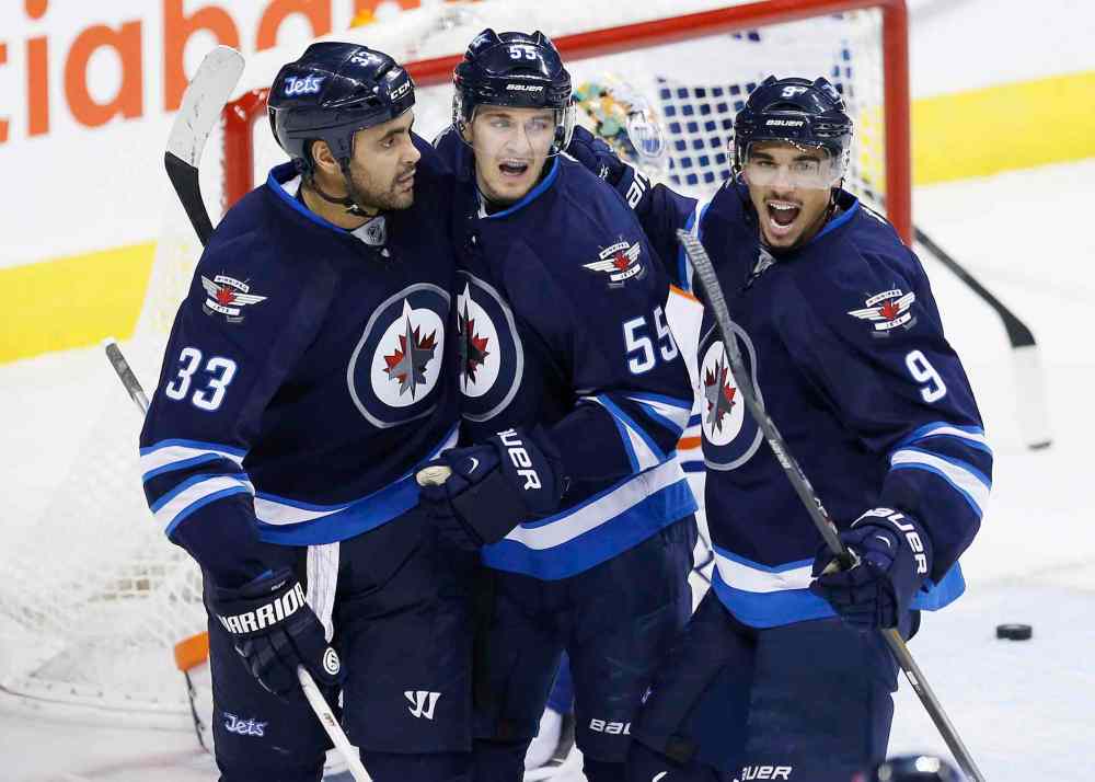 John Woods / The Canadian Press
Winnipeg Jets' Dustin Byfuglien (33), Mark Scheifele (55) and Evander Kane (9) celebrate Byfuglien's game-tying goal against the Edmonton Oilers during third period NHL action in Winnipeg.