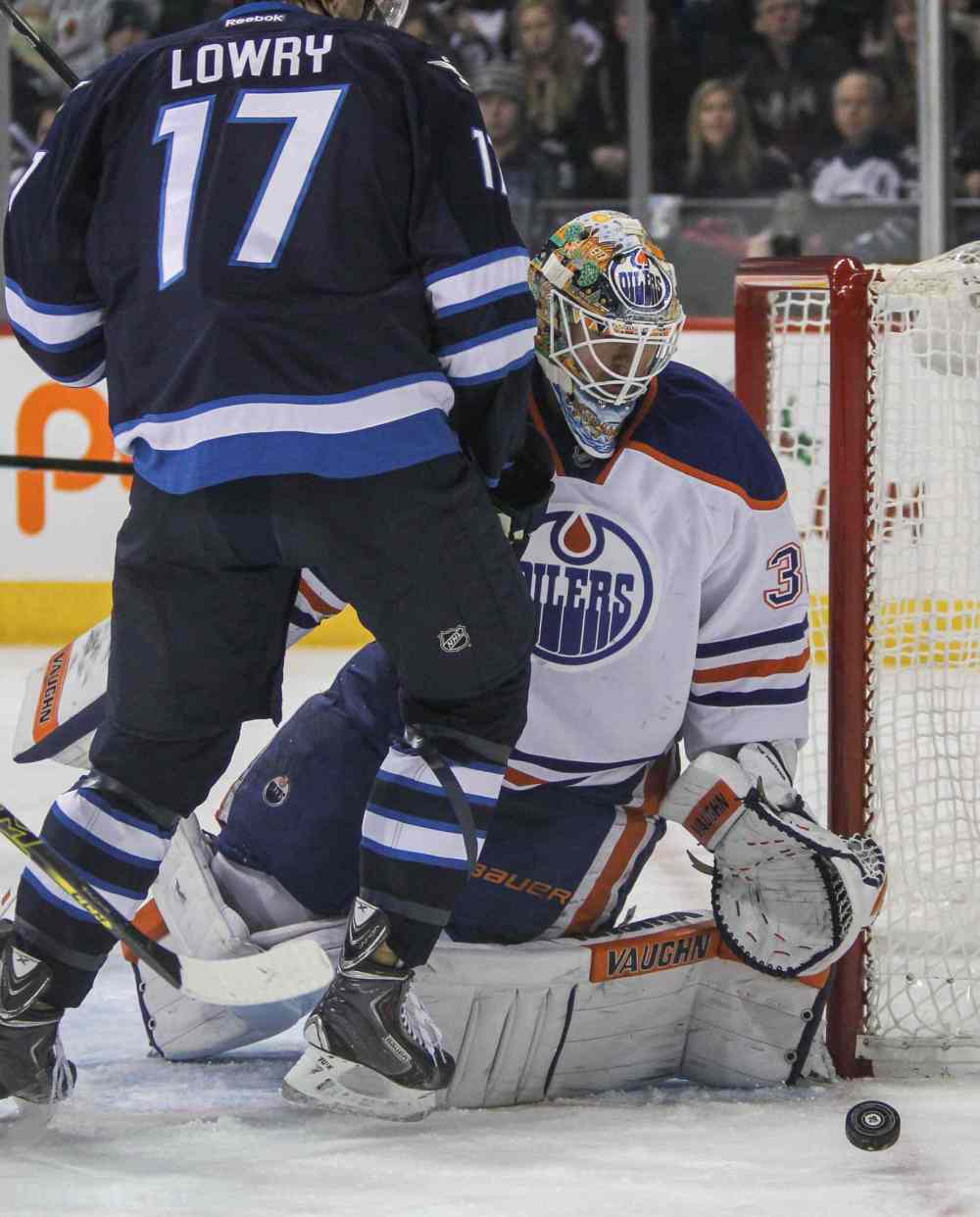 MIKE DEAL / WINNIPEG FREE PRESS
Winnipeg Jets' Adam Lowry (17) tries to get the puck past Edmonton Oilers' goaltender Ben Scrivens (30).