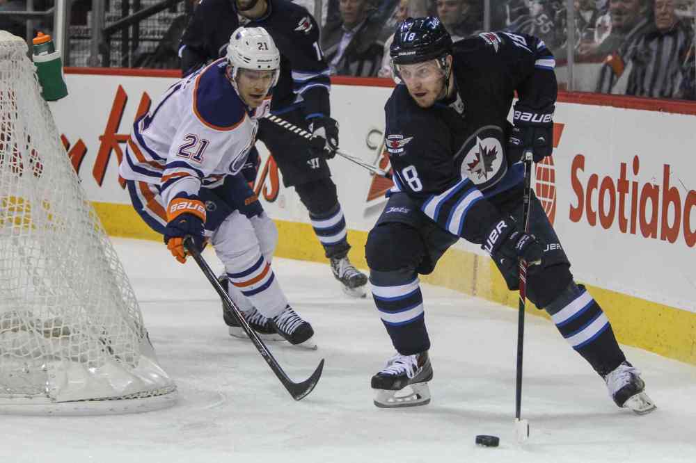 MIKE DEAL / WINNIPEG FREE PRESS
Winnipeg Jets' Bryan Little (18) gets behind the Oilers net while Edmonton Oilers' Andrew Ference (21) tries to keep up during NHL action in Winnipeg.