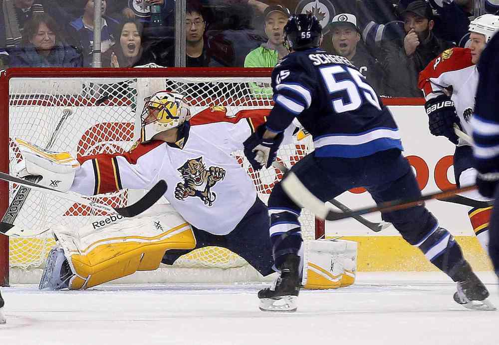 Trevor Hagan / The Canadian Press
Winnipeg Jets' Mathieu Perreault (85), not shown, opens the scoring as he puts the puck past Florida Panthers goaltender Roberto Luongo (1), with Jets' Mark Scheifele (55) in front of the net, during first period NHL hockey action in Winnipeg, Tuesday.