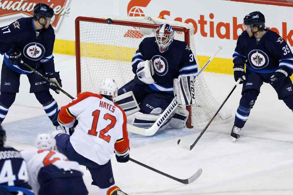 John Woods / Winnipeg Free Press
Florida Panthers' Jimmy Hayes' (12) shot hits the cross bar after going off the shoulder of Winnipeg Jets goaltender Michael Hutchinson (34) during first period.