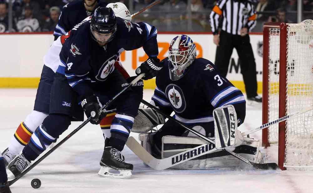 Trevor Hagan / The Canadian Press
Winnipeg Jets' Zach Bogosian (44) and Florida Panthers' Brad Boyes (24) battle for the puck in front of goaltender Michael Hutchinson (34) during first period.