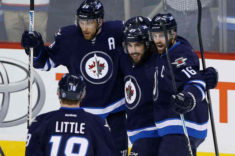 John Woods / Winnipeg Free Press
Winnipeg Jets' Mathieu Perreault (85) celebrates his first-period goal against the Florida Panthers with Blake Wheeler (26), Andrew Ladd (16) and Bryan Little (18).
