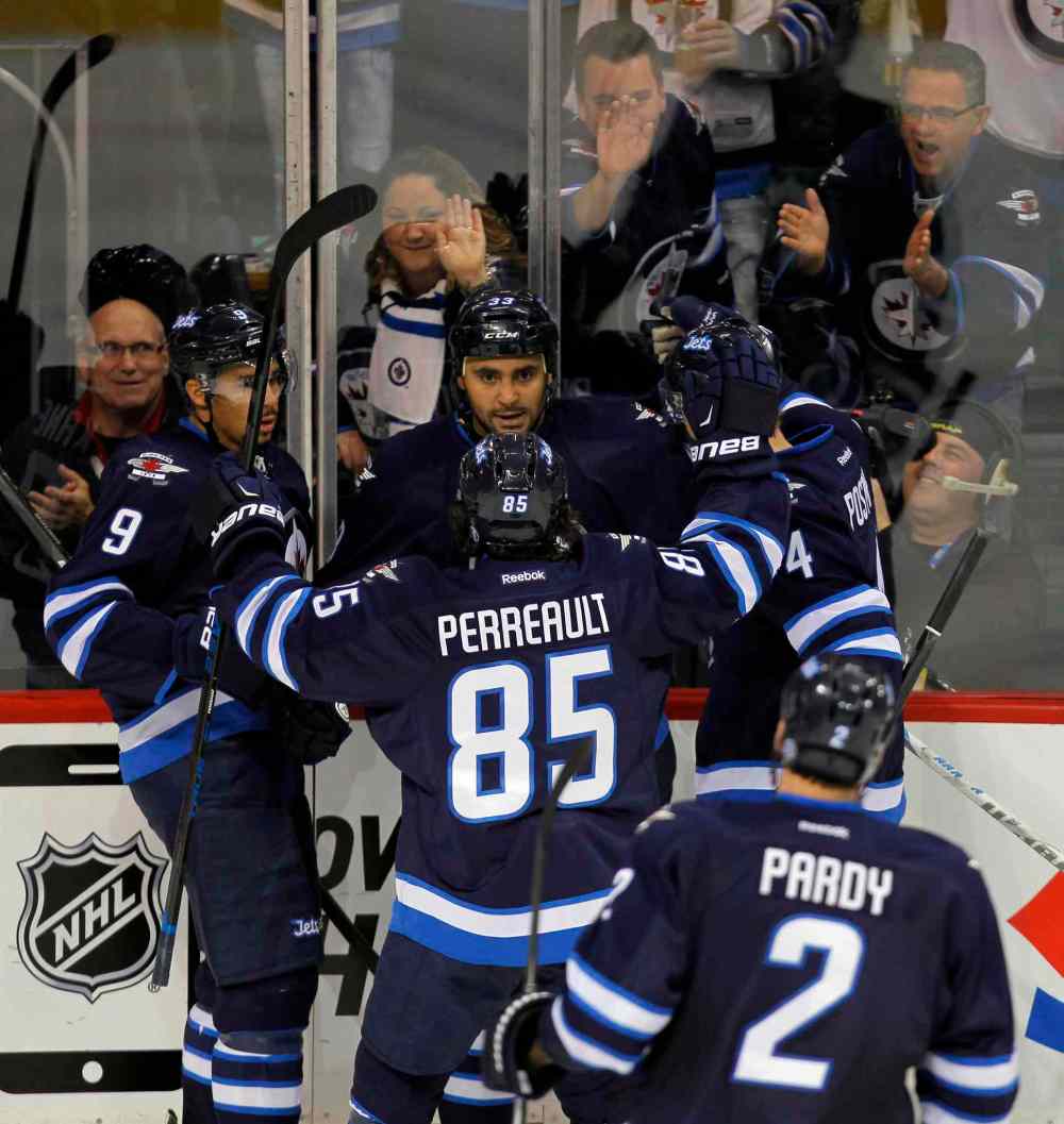 BORIS MINKEVICH / WINNIPEG FREE PRESS
Dustin Byfuglien celebrates his second-period goal with his Jets teammates.