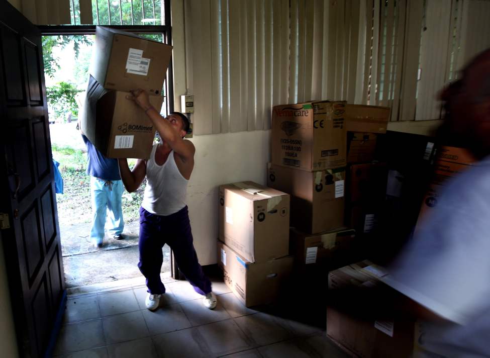 A delivery man juggles a stack of boxes as the Op-Walk's medical supplies arrive at the hospital in Managua.