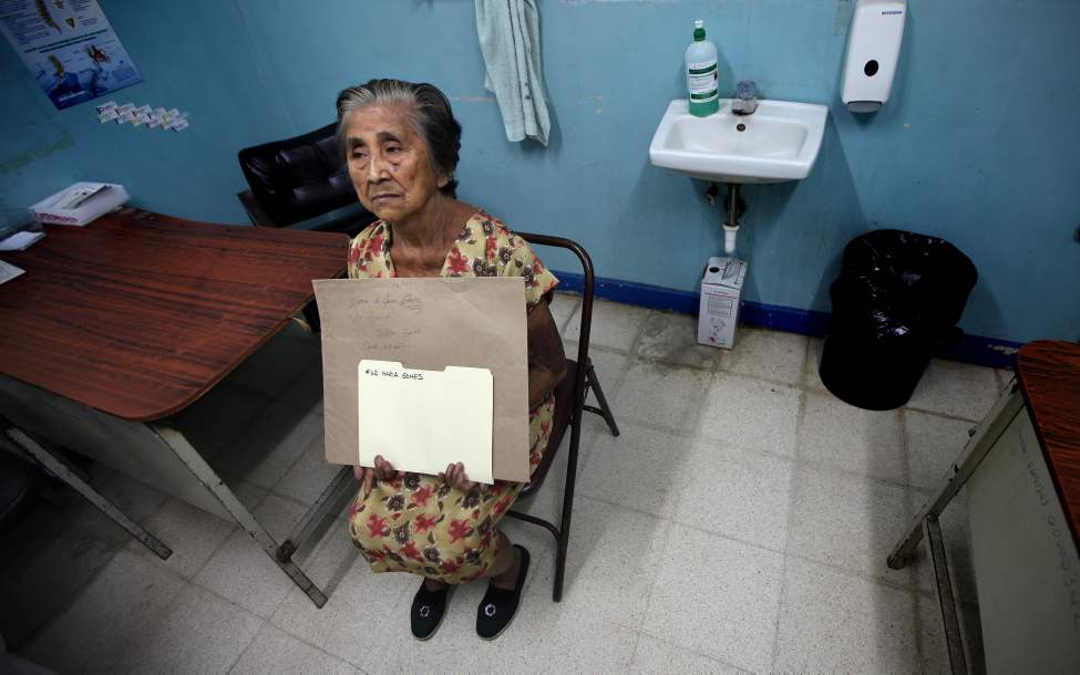 Surgical candidate Maria Gomez clutches her files and x-rays as she waits.