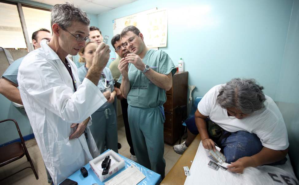 Dr Stephen Henry (left) and Dr Tom Turgeon and a combined team of specialists from Winnipeg and Managua, check a patients medication.