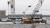 A VIA Rail train is lifted onto a ship in Churchill, Man.