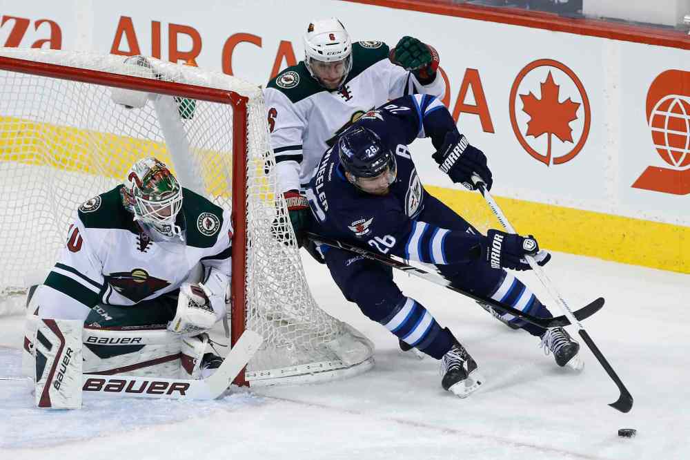 John Woods / Winnipeg Free Press
Winnipeg Jets' Blake Wheeler (26) attempts the wrap-around against Minnesota Wild goaltender Devan Dubnyk (40) as Wild's Marco Scandella (6) defends during first period.