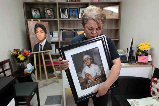 Ruth BonnevilleImelda Adao, whose son Jaime, 17, was killed in 2019 in a home invasion, stands in her office surrounded by photos of her son.  (RUTH BONNEVILLE / WINNIPEG FREE PRESS FILES)