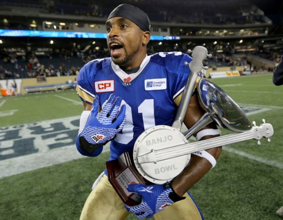 TREVOR HAGAN / WINNIPEG FREE PRESSWinnipeg Blue Bombers' Maurice Leggett (31) celebrates with the Banjo Bowl trophy after defeating the Saskatchewan Roughriders.