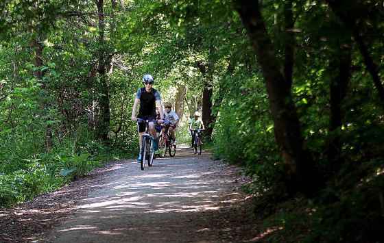 PHIL HOSSACK / WINNIPEG FREE PRESSCyclists make their way along Bunn's Creek Parkway, just one of many lesser-known parks profiled in Sunday's paper by Brenda Suderman.