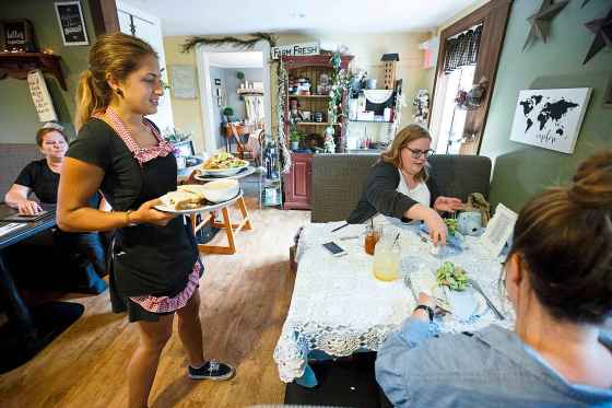 MIKE DEAL / WINNIPEG FREE PRESS Kailyn serves Erin Lebar (centre) and Jen Zoratti a chicken salad sandwich and the Farmhouse salad at The Ole’ Farmhouse Café in Rosenort. Lebar and Zoratti did a foodie's road trip through parts of rural Manitoba.