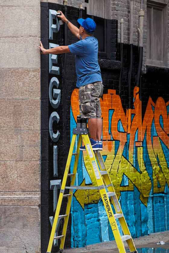 MIKE DEAL / WINNIPEG FREE PRESS Skan from Toronto works on a piece just off of Albert Street as part of Paint the Peg, an initiative to bring curated street art to the Exchange District.