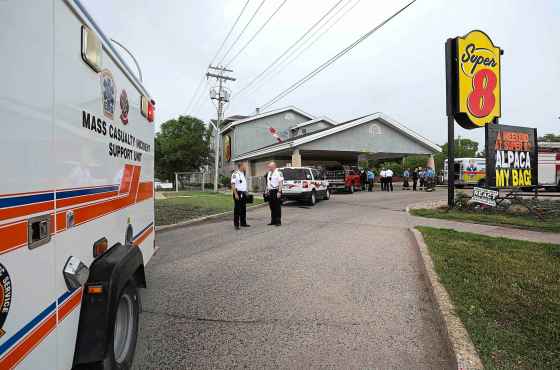 RUTH BONNEVILLE /  WINNIPEG FREE PRESS Emergency crews and vehicles are parked outside the Super 8 Motel on Portage Avenue after a carbon monoxide leak sent dozens to hospital on Tuesday.
