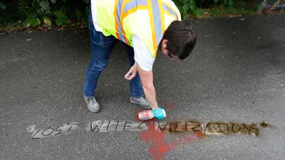 WAYNE GLOWACKI / WINNIPEG FREE PRESSBrennan Dugas with Take Pride Winnipeg was part of a crew removing  graffiti on Wellington Crescent and in the Omand Park area Wednesday morning. Here, he cleans up an offensive message and bad spelling on the sidewalk on the Omand's Creek Greenway at the foot of the bridge over the Assiniboine River.