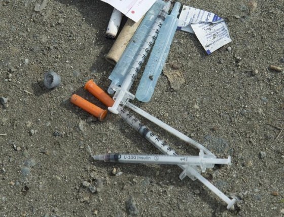 Needles on the ground in Oppenheimer Park in Vancouver. (Jonathan Hayward / The Canadian Press files)