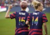 U.S. forward Megan Rapinoe,left, and defender Emily Sonnett line up with teammates for a team photo before an international friendly soccer match against Colombia on Saturday, June 25, 2022, in Commerce City, Colo. (AP Photo/David Zalubowski)