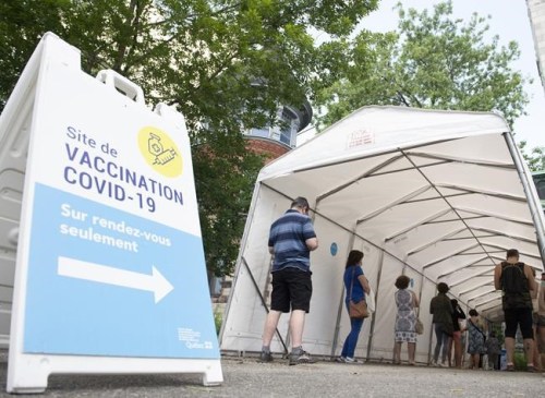 Canada handled the first two years of the COVID-19 pandemic and weathered the ensuing upheaval better than several other nations with comparable health-care and economic infrastructure, a new study suggests. People wait in line to receive a COVID-19 vaccine in Montreal, Saturday, June 19, 2021. THE CANADIAN PRESS/Graham Hughes