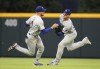 Los Angles Dodgers outfielder Trace Thompson, right, runs down a fly ball for the out on Atlanta Braves' Orlando Arcia's fly ball and avoids the collision with Dodgers' Gavin Lux during the fourth inning of a baseball game, Sunday, June 26, 2022, in Atlanta. (Curtis Compton/Atlanta Journal-Constitution via AP)