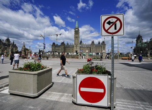 Signs are pictured on Parliament Hill prior to Canada Day, in Ottawa on Monday, June 27, 2022.&nbsp;Ottawa's mayor and chief of police say they are ready as the city braces for a new round of protests that are expected to start on Canada Day. THE CANADIAN PRESS/Sean Kilpatrick