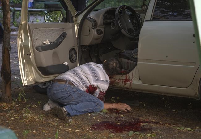 EDS NOTE: GRAPHIC CONTENT - A dead body of a man killed by the Russian shelling in city center in Slavyansk, Donetsk region, Ukraine, Monday, June 27, 2022. (AP Photo/Efrem Lukatsky)