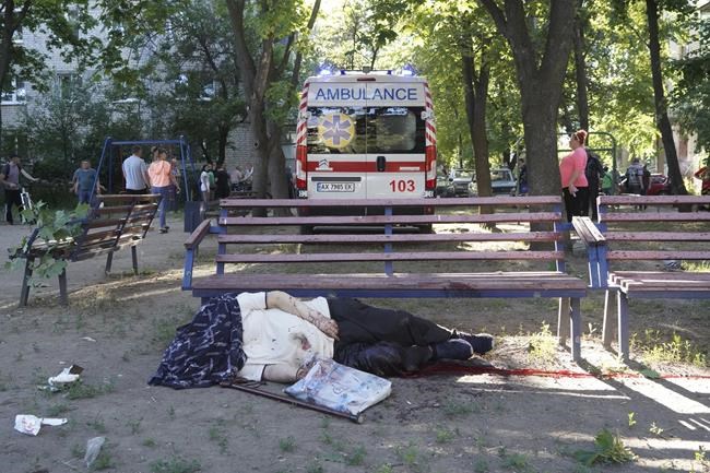 EDS NOTE: GRAPHIC CONTENT - A body of a man killed during shelling lies in a yard of an apartment building in Kharkiv, Ukraine, Monday, June 27, 2022. (AP Photo/Andrii Marienko)