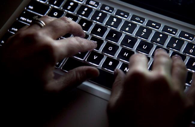 A woman uses a computer keyboard in North Vancouver, B.C., on December 19, 2012. Canada's cyberspy agency launched a defensive operation to protect last year's federal election — including the party leaders's debate — from disruption by foreign agencies, its annual report published today says.THE CANADIAN PRESS/Jonathan Hayward