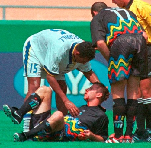FILE - Miami Fusion's Tyrone Marshall (15) assists Kansas City Wizards' Scott Vermillion after the two collided while going up for a header in the first half of a soccer match Sunday, Aug. 29, 1999, in Kansas City, Mo. Researchers have diagnosed chronic traumatic encephalopathy in a Major League Soccer player for the first time, saying Tuesday, June 28, 2022, that former Sporting Kansas City defender Scott Vermillion suffered from the degenerative brain disease. (AP Photo/Ed Zurga, File)