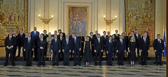 U.S. President Joe Biden, center left, speaks with Spain's King Felipe, center, during a group photo alongside other heads of state and dignitaries before a gala dinner at the Royal Palace in Madrid, Spain, Tuesday, June 28, 2022. North Atlantic Treaty Organization heads of state will meet for a NATO summit in Madrid from Tuesday through Thursday. (AP Photo/Andrea Comas)