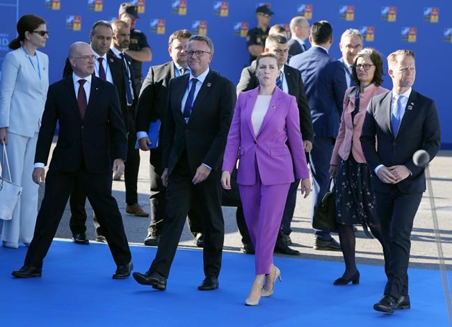 Denmark's Prime Minister Mette Frederiksen, center right, arrives for the NATO summit in Madrid, Spain on Wednesday, June 29, 2022. North Atlantic Treaty Organization heads of state will meet for a NATO summit in Madrid from Tuesday through Thursday. (AP Photo/Paul White)