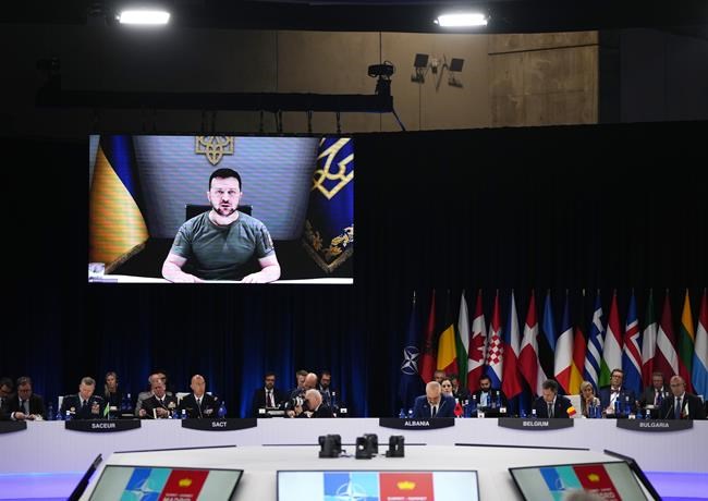 Ukraine's President Volodymyr Zelenskyy addresses leaders via a video screen during a round table meeting at a NATO summit in Madrid, Spain on Wednesday, June 29, 2022. North Atlantic Treaty Organization heads of state meet for a NATO summit in Madrid from Tuesday through Thursday. (AP Photo/Manu Fernandez)